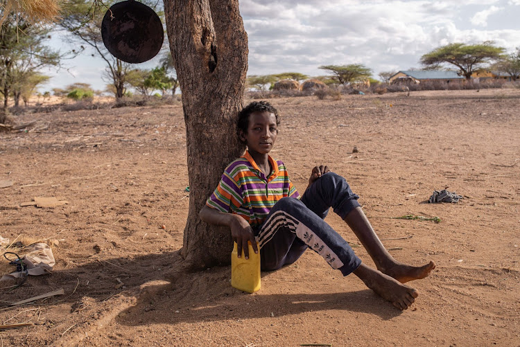 Kassim sits beneath a tree near his home in a remote village in Garissa.