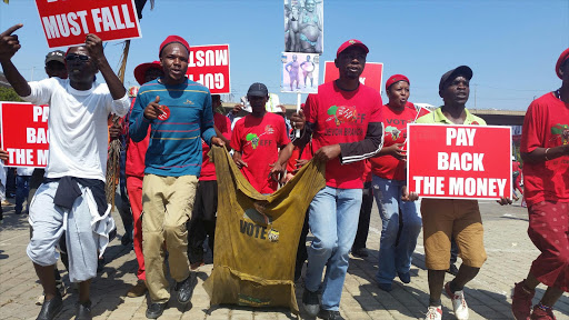 Fighters drag an old ANC overall around the square. Picture: Shenaaz Jamal