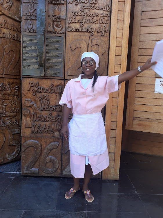 An ecstatic Sylvia Mahlangu outside the Constitutional Court holds the historic judgment.