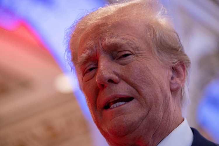 Former U.S. President Donald Trump talks to the press on the grounds of his Mar-a-Lago resort on midterm elections night in Palm Beach, Florida, U.S. November 8, 2022.