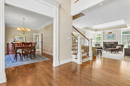 Dining room and living room with staircase - Buy this luxury property in Bridgewater Township, 4 bedrooms