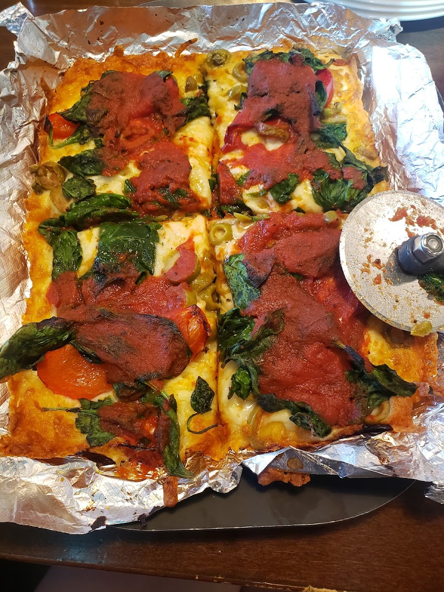 Baked on foil and served uncut with a clean pizza cutter.