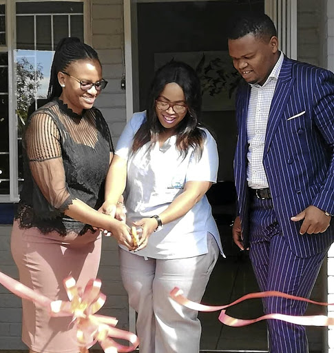 Phindiwe Kula and Dipuo Madonsela cutting the ribbon to open the Spectrum Pathology Laboratory in Carletonville. /SUPPLIED