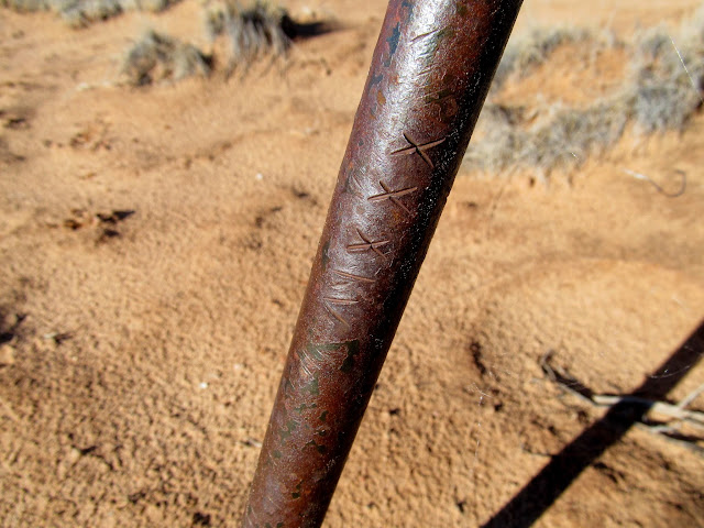 XXXIV stamped into a metal rod