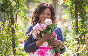 Advocate Thuli Madonsela poses with the rose that's been named in her honour by Ludwig's Roses.