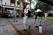 Azola Lukhozi,12, a grade 7 pupil at Clifton College in Durban is getting disinfected as he enters the schools premises. 