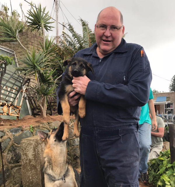 Dave Steyn of the SAPS Search and Rescue Unit with a German Shepherd puppy from a house that collapsed in the Bluff, south of Durban.