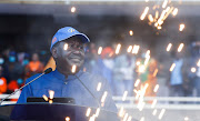 Kenya's Opposition leader Raila Odinga is seen through confetti firework as he addresses the Azimio la Umoja (Declaration of Unity) rally to unveil his August 2022 Presidential race candidature at the Moi International Sports centre in Kasarani, Nairobi on December 10, 2021. 