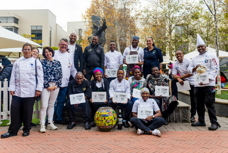 A group photo featuring the competition winners and stakeholders.