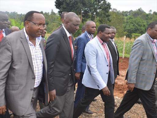 FUTURE RIVALS: Chuka Igambang’ombe MP Muthomi Njuki (right) and Tharaka Nithi Governor Samuel Ragwa (far left) accompany Deputy President William Ruto at Mukuuni, Chuka Igambang’ombe, on June 2015 during the opening of a grain storage facility. The two will face off in the Tharaka Nithi gubernatorial polls in 2017.