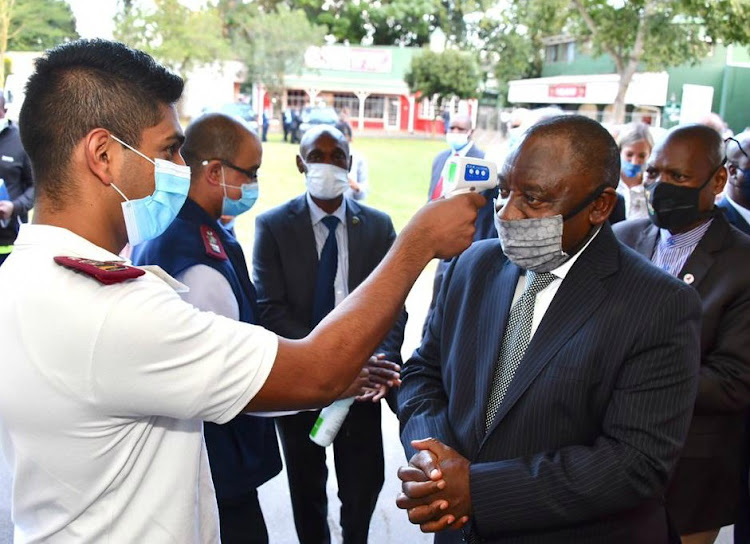 President Cyril Ramaphosa has his temperature checked before touring the quarantine site at the Royal Showgrounds in Pietermaritzburg on Tuesday.