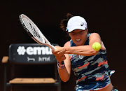 Iga Swiatek of Poland plays a backhand against Ons Jabeur of Tunisia during the women's single's final of the Internazionali BNL D'Italia at Foro Italico in Rome on May 15 2022.