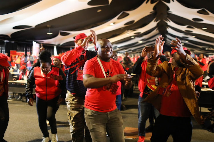 Members of the SACP sing struggle songs as outgoing general secretary Blade Nzimande stands to deliver an address during the party’s elective congress.