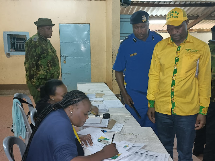 Gichugu MP Gichimu Githinji awaiting for the finalization of his UDA party certificate at the Gichugu constituency tallying center in Kianyaga on Friday.