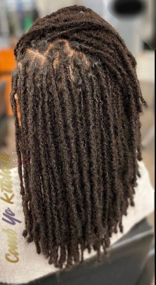 Back view of lady showing off her full locs 