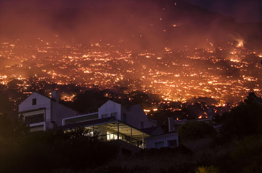 A private residence is seen in close proximity to the glowing embers left behind after the Simon's Town fire.