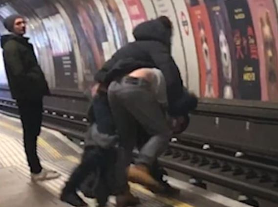 Video footage caught the moment the two men fell into the path of the Tube train and are pulled out by other commuters.