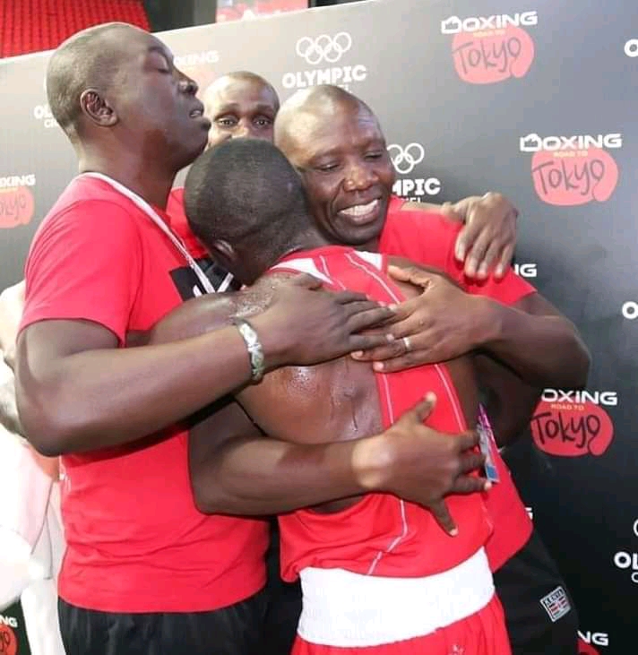 Hit Squad coaches Benjamin Musa and Dave Munuhe congratulate featherweight Nick Okoth after winning a past bout.