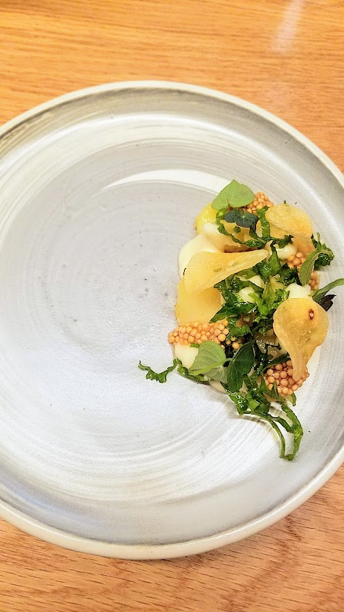 Farm Spirit, an all vegan restaurant, Potato with preserved local lemon citrus, onion cream, fermented seed mustard and mustard greens, potato chips, tangerine sage