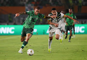 William Ekong of Nigeria challenged by Frank Magri of Cameroon during their Africa Cup of Nations last-16 match at the Felix Houphouet Boigny Stadium in Abidjan.