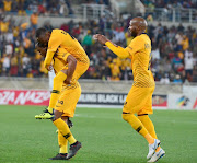 Kaizer Chiefs midfielder Khama Billiat jumps on goalscorer Siphiwe Tshabalala with Ramahlwe Mphahlele (R) to celebrate a goal during the Absa Premiership match against Baroka FC at Peter Mokaba Stadium on August 14, 2018 in Polokwane, South Africa.