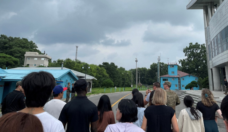 US Private Travis T. King (wearing a black shirt and black cap) is seen in this picture taken during a tour of the tightly controlled Joint Security Area on the border between the two Koreas on July 18 2023. Picture: SARAH LESLIE/HANDOUT via REUTERS