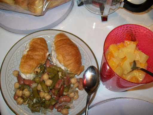 three bean salad with tuna sandwiches and fruit salad.