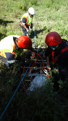 Emergency personnel freeing a body of a man who was trapped in his car after it plunged down a cliff. Picture: SUPPLIED