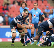 Derick Minnie of the Lions spreads the ball during the Absa Currie Cup match between Xerox Golden Lions and Vodacom Blue Bulls at Ellis Park on August 09, 2014 in Johannesburg, South Africa.