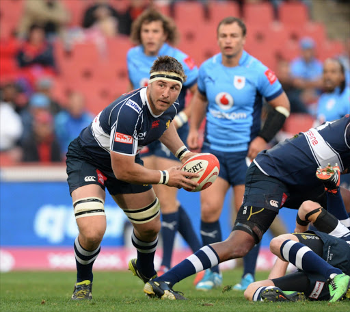 Derick Minnie of the Lions spreads the ball during the Absa Currie Cup match between Xerox Golden Lions and Vodacom Blue Bulls at Ellis Park on August 09, 2014 in Johannesburg, South Africa.