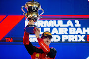 Charles Leclerc celebrates on the podium after winning the F1 Grand Prix of Bahrain at Bahrain International Circuit on March 20, 2022 in Bahrain.