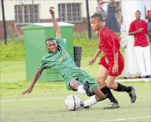 All out: Thabiso Gwabavu of Pimville Westham fights for the ball with Terrence Maluleke of Diepkloof Barsenal. PHOTO: VELI NHLAPO