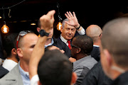 Israeli prime minister Benjamin Netanyahu waves as he visits Mahane Yehuda market in Jerusalem a day ahead of the national elections. 