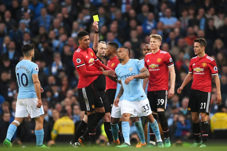 Gabriel Jesus of Manchester City is shown a yellow card by referee during the Premier League match between Manchester City and Manchester United at Etihad Stadium on April 7, 2018 in Manchester, England.