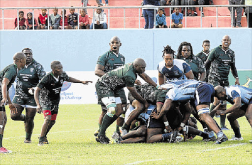 DIGGING DEEP: A Swallows player digs out the ball out of a ruck while Winter Rose players line up in defence in their Border Super League clash at the Sisa Dukashe Stadium Picture: RANDELL ROSKRUGE