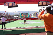 Gerda Steyn crosses the Comrades Marathon finish line in 2019. 