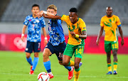 Ritsu Doan of Japan and Sibusiso Mabiliso of South Africa during the Tokyo 2020 Olympic Games men's football match between Japan and South Africa at Tokyo Stadium on July 22, 2021 in Tokyo, Japan. 