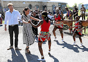 Prince Harry and Meghan Markle get a warm welcome at  the Justice Desk in Nyanga, which is supported by the Queen's Commonwealth Trust. 