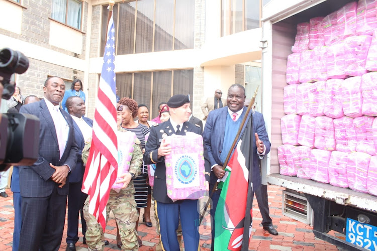 USAID Kenya Deputy mission Director Bert Ubamadu, US sergent Pablo Zuniga and Julius Jwan during the launch of sanitary pads for both primary and secondary school girls at KICD on Monday, November 7, 2022.