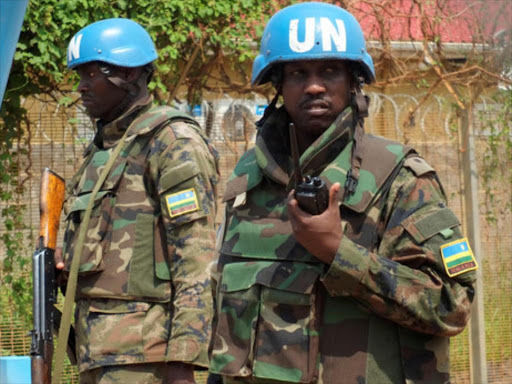 Rwandan peacekeepers serving in the United Nations Mission in South Sudan (UNMISS) stand guard inside their compound as members of the civil society and political parties participate in a protest against foreign military deployment to South Sudan in the capital Juba, July 20, 2016. /REUTERS