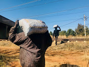 Unemployed youths collect coal along the railway lines and sell it for R50 a bag.