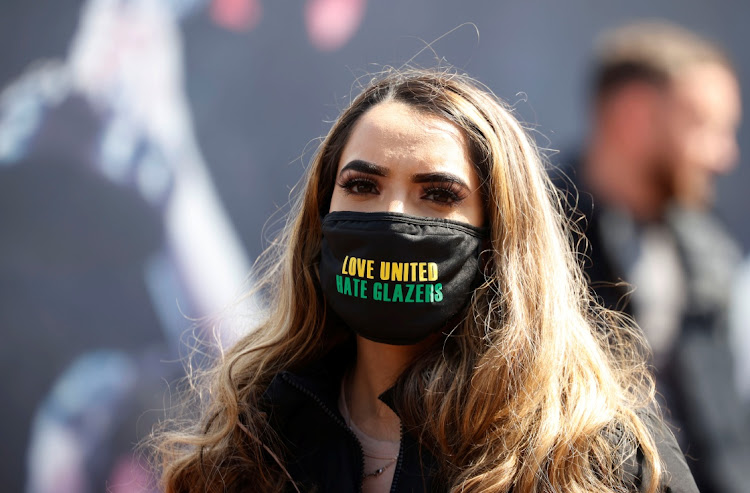 A Manchester United fan protests against the club's owners before the Manchester United versus Liverpool Premier League match at Old Trafford on May 2, 2021