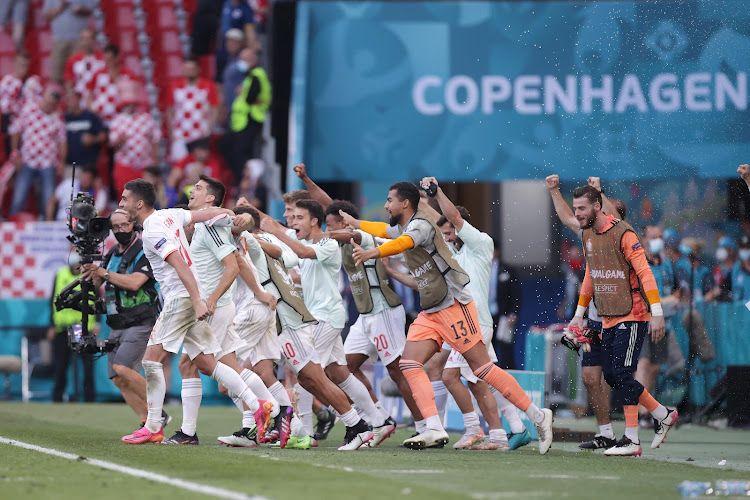 Spain players celebrate with their fans after the final whistle.