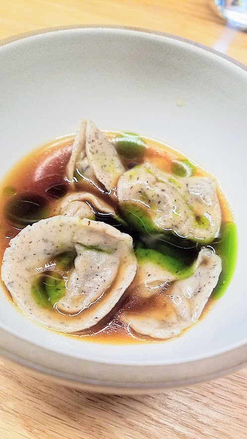 Farm Spirit, an all vegan restaurant, Mushroom duxelle dumplings with buckwheat pasta, nourishing broth, bay laurel oil