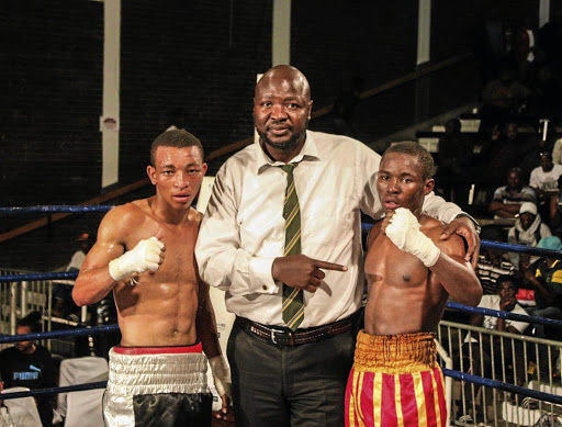 Promoter Ayanda Matiti is flanked by young boxing prospects Sabelo Nkosi, left, and Ntlantla Tyira at Orient Theatre recently.