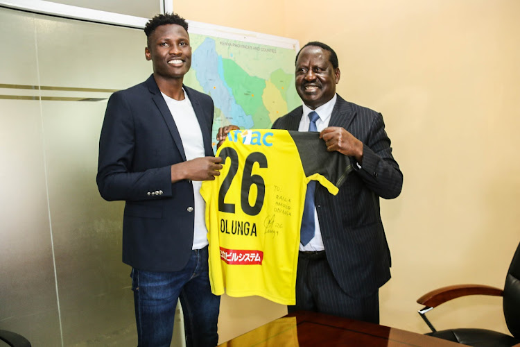 Harambee Stars striker Michael Olunga with former Prime Minister Raila Odinga when the Japan-based forward briefed his host on plans to stage football tournaments in Nairobi and Homabay counties later this month.