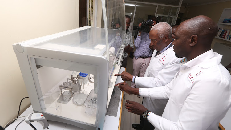 National Research Fund chairman board of trustees Ratemo Michieka with Benson Nyambega Principal investigator at the research center during its launch.