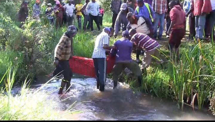 Residents retrieve the body of a pupil who was among two others who drowned in Kiama River last week.