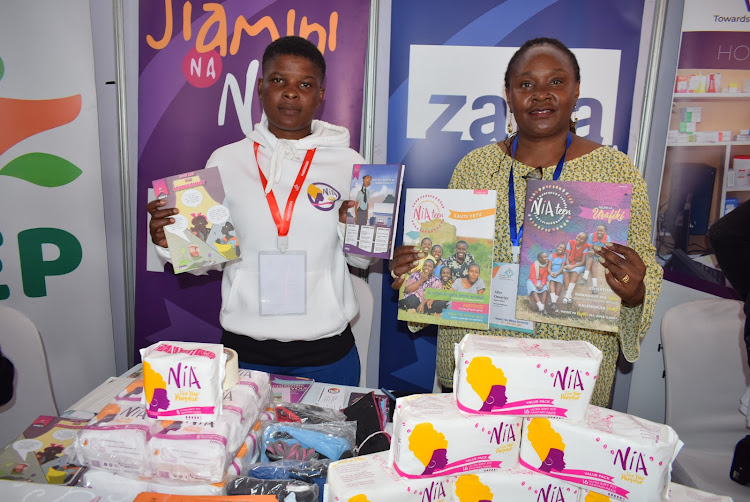 Zana Africa officials led by programmes manager Alice Onsarigo display learning materials at Tom Mboya University grounds in Homa Bay town on February 29,2024