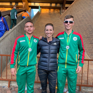 Heat Athletics Club medallists, Cole Moultrie, left, and Keenan Adams, with high performance coach Jessi Kahn